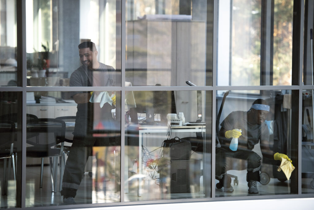 full shot smiley man cleaning window